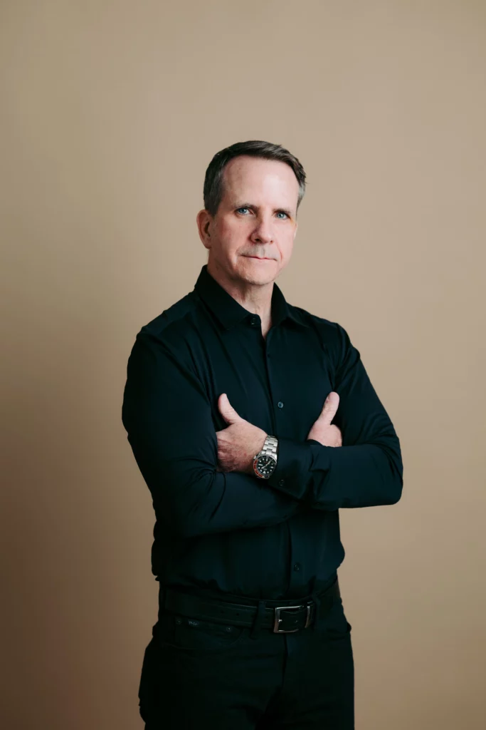 a man in black shirt with his arms crossed